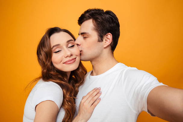 Young lovely couple posing together with klosed eyes - Foto, Imagem