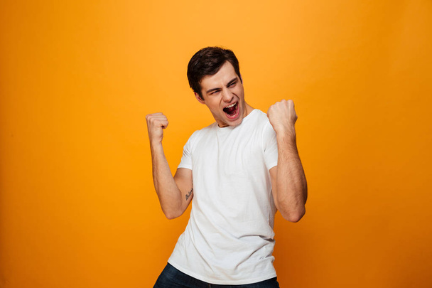 Image of Happy man in t-shirt rejoice with open mouth - Фото, зображення