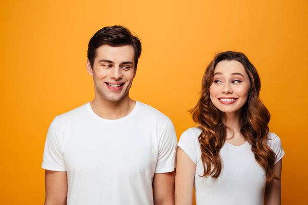 Photo of happy boyfriend and girlfriend in white t-shirts smilin - Фото, зображення