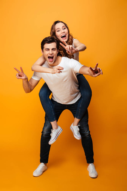Full length image of Cheerful young lovely couple having fun - Photo, Image