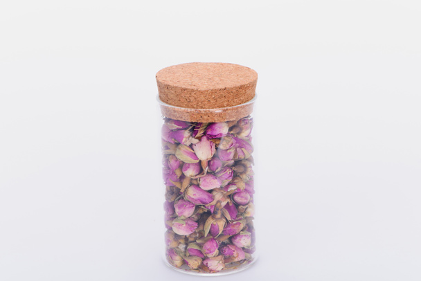 close-up view of dry pink rose buds in glass jar isolated on white  - Photo, Image