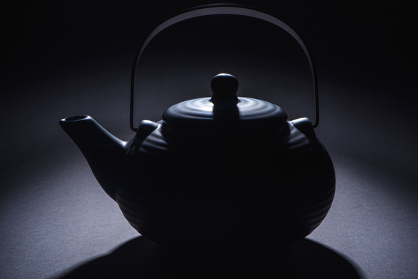 close-up view of black traditional chinese teapot on black - Foto, immagini