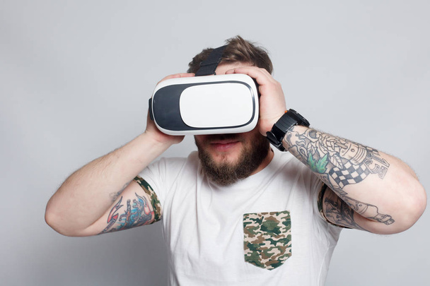 Color shot of a young man looking through a virtual reality - Fotó, kép