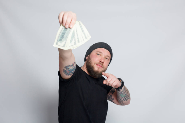 Young man throws money to camera. - Zdjęcie, obraz
