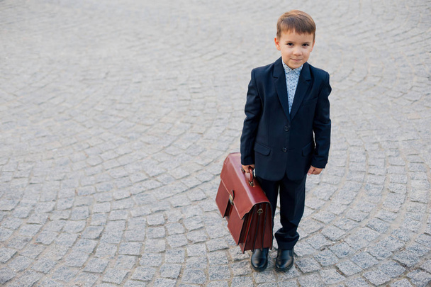 Future businessman in formal costume with briefcase - Foto, imagen