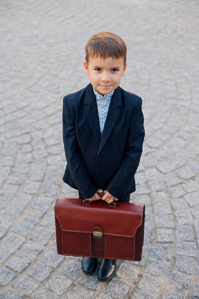 Smiling future businessman in formal costume with briefcase - Valokuva, kuva