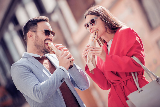 Couple having lunch outdoors,eating sandwiches. - Fotó, kép