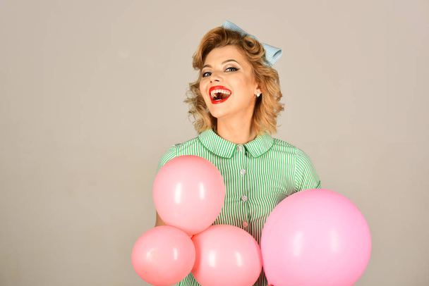 beautiful pin-up retro woman playing with pink balloons - 写真・画像