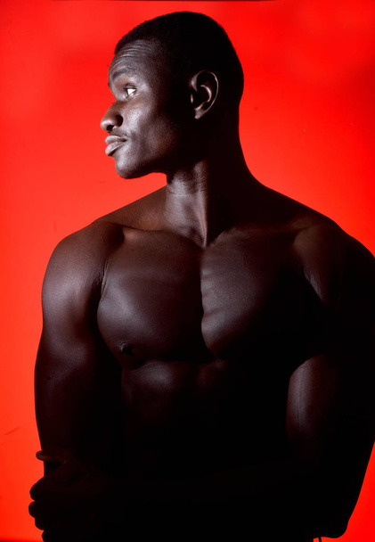 portrait of an african man shirtless on red background - Foto, Imagem