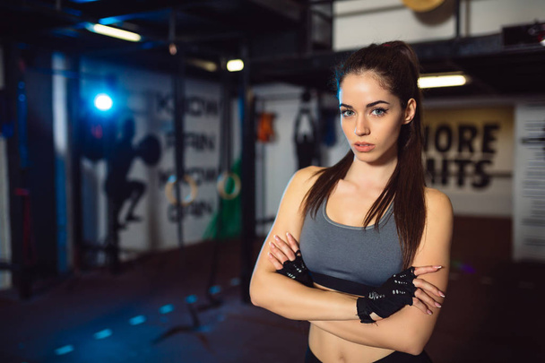 Portrait of an attractive young sporty girl in the gym. - Photo, Image