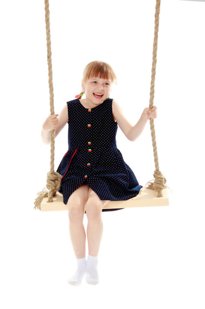 Little girl swinging on a swing - Fotoğraf, Görsel