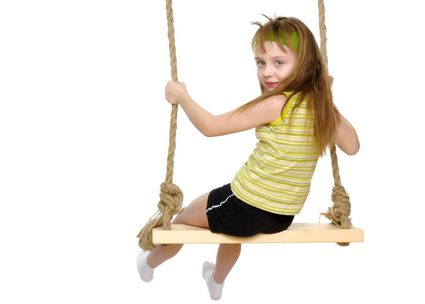 Little girl swinging on a swing - Photo, image