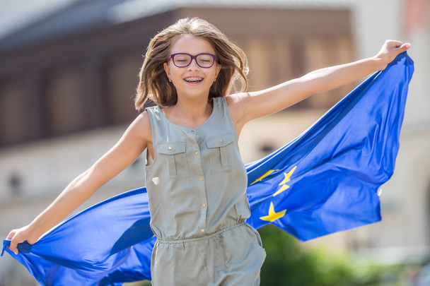 EU Flag. Cute happy girl with the flag of the European Union.  - Фото, зображення