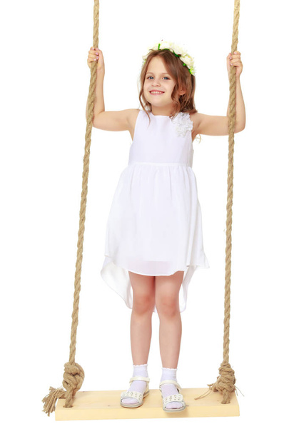 Little girl swinging on a swing - Φωτογραφία, εικόνα