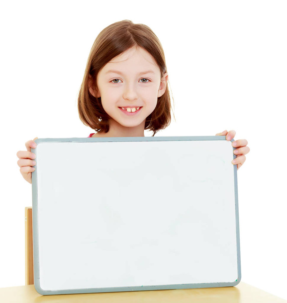 Little girl holding white poster. - Foto, Imagen