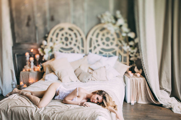 Beautiful boudoir morning of the bride on the bed. - Фото, изображение