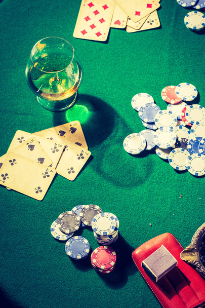 Chips and cards on green vintage table for poker - Фото, зображення