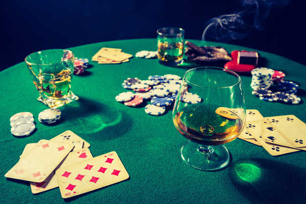 Cards and chips in vintage gambling green table - Foto, imagen