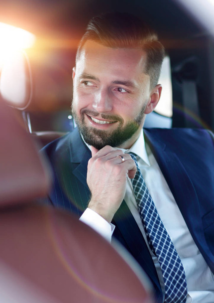 Close-up of a successful businessman sitting in a comfortable car - Valokuva, kuva
