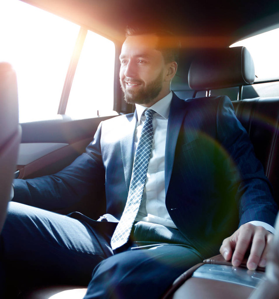 businessman sitting in the back seat of a car - Фото, зображення