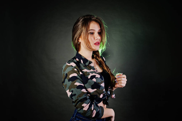 Handsome brunette girl wear military shirt and jeans, posing at  - Фото, зображення