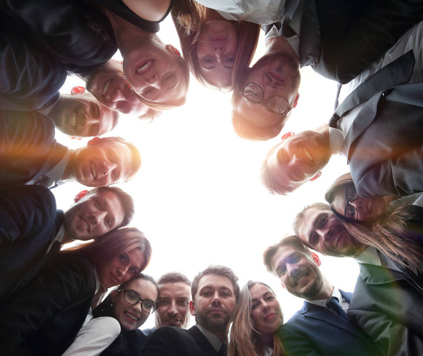 large business team is forming a circle and looking at the camer - Fotografie, Obrázek