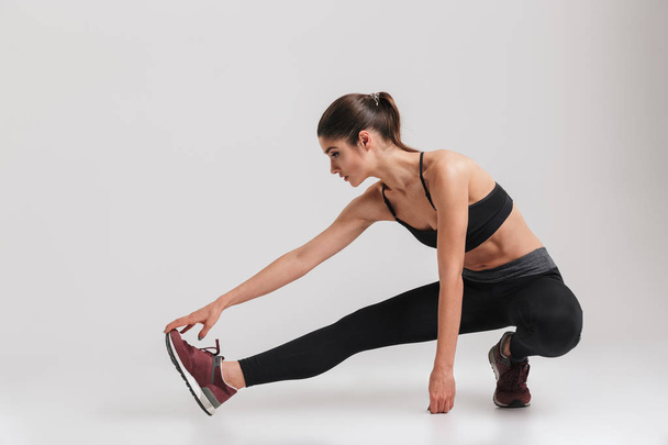 Full-length image of sporty woman with flexible body squatting a - Photo, Image