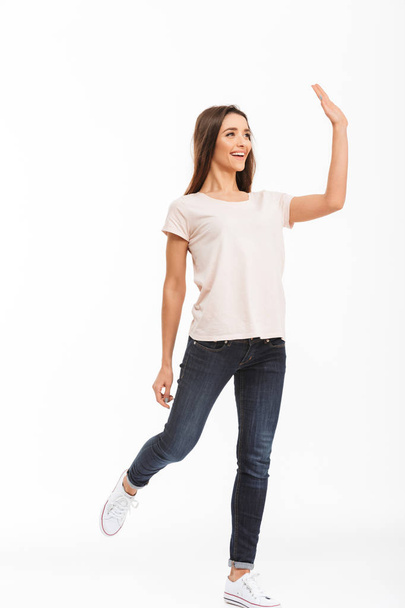 Full length image of Happy brunette woman in t-shirt walking - Valokuva, kuva