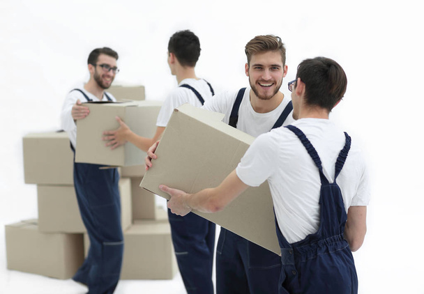 Portrait of movers holding box smiling isolated on white backgro - Фото, зображення