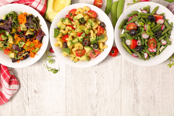 Top view of assorted vegetable salad bowls. - Фото, изображение