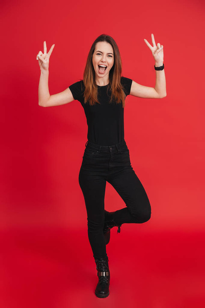 Full-length image of joyful woman in total black outfit posing o - Photo, image