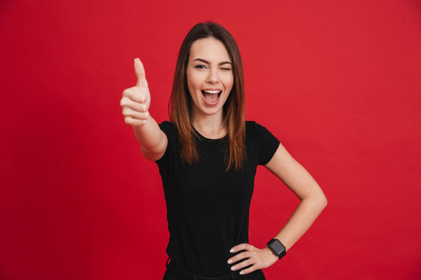 Portrait of a joyful casual girl showing thumbs up - Photo, image
