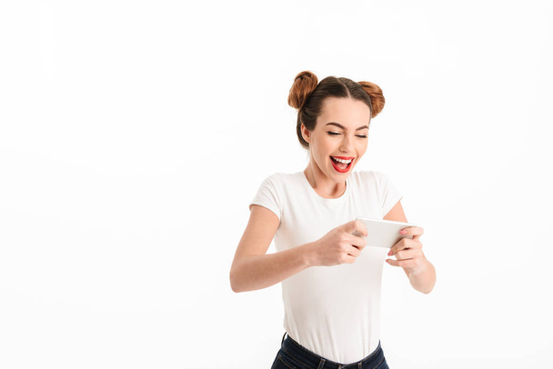 Portrait of an excited casual girl playing games - Foto, afbeelding