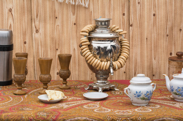 The concept of tea drinking. Samovar, bagels and tea set on the Shrovetide holiday - Photo, Image
