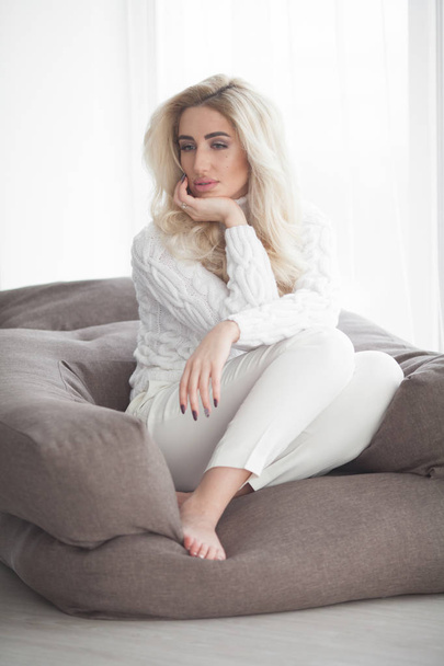 Sexy blonde girl in the white sweater - Photo, image