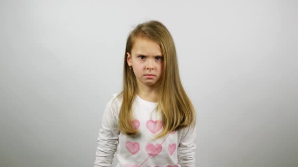 The young girl looking angry and begins to cry. A frustrated child crying looking straight  - Footage, Video