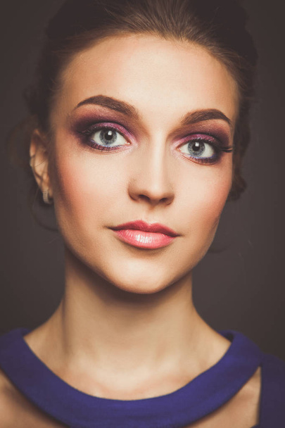 Studio shot of a beautiful young woman wearing professional makeup. - Valokuva, kuva