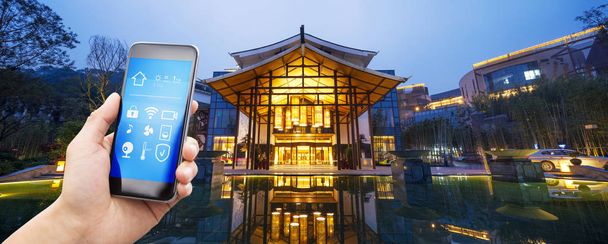 smartphone with smart home and modern business hotel - Photo, Image