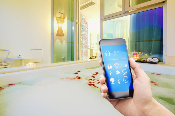 smartphone with smart home and modern bathroom in spring hotel - Photo, Image