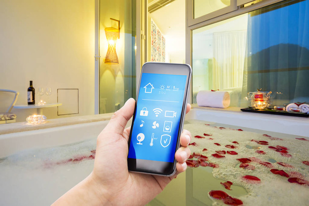 смартфон со смарт-домом и современной ванной комнатой в весеннем отеле
 - Фото, изображение