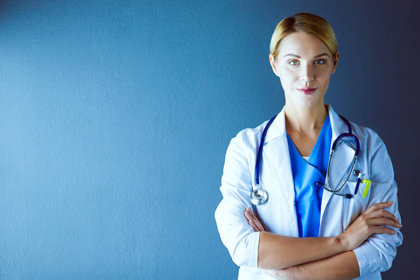 Portrait of young woman doctor with white coat standing in hospital. - Photo, image