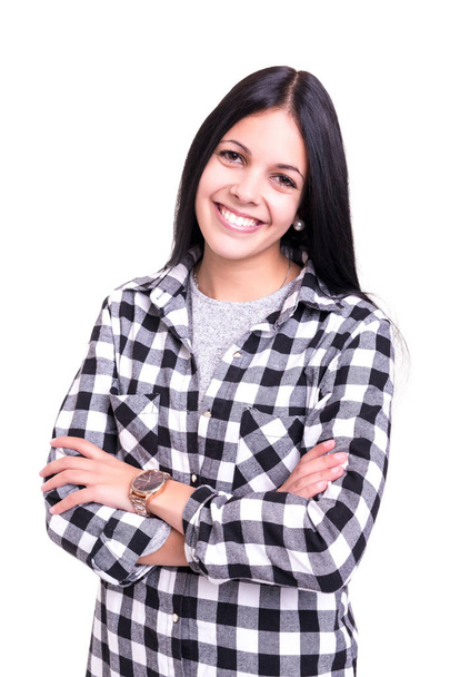 Studio shot of a beautiful young casual woman in checked shirt with crossed arms - Photo, Image