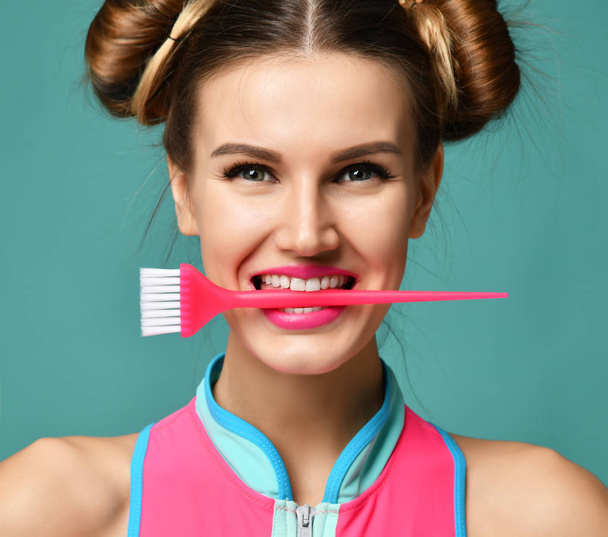 brunette woman with colorful pink basic applicator hair tint brush  - Foto, immagini
