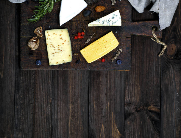  cheese on a brown cutting board: roquefort, brie, cheese with w - Photo, Image
