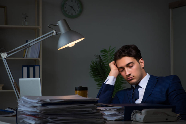 Businessman tired and sleeping in the office after overtime hours - Photo, Image