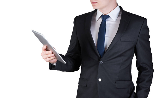 Businessman standing while using tablet computer, isolated on white background - Foto, imagen
