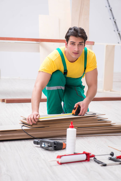 Contractor working on laminate wooden floor  - Photo, Image