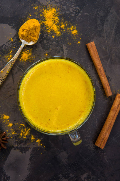 Golden turmeric milk with cinnamon. Healthy and aromatic detox b - Fotó, kép