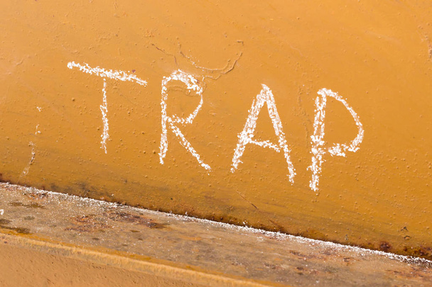 Trap handwriting with chalk on orange metal background - Photo, Image