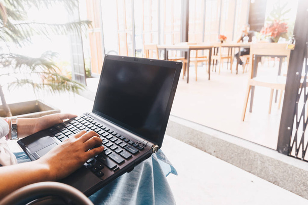 Le donne d'affari usano il computer portatile che si siede sulla panchina in caffè, comunicazione commerciale
 - Foto, immagini